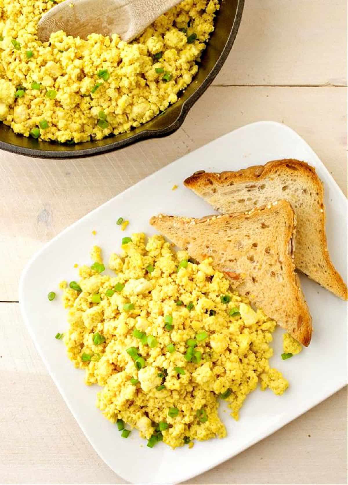 Tofu scramble and toast on a white plate.