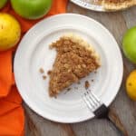 A slice of vegan dutch apple pear pie on a white plate.