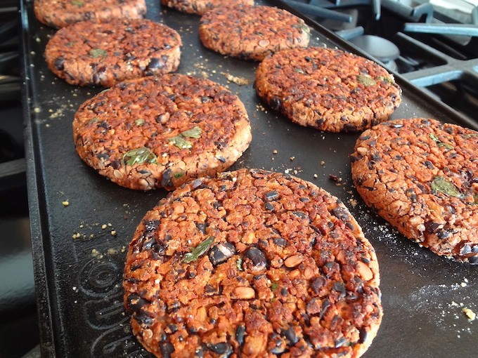 No crumble black bean burgers cooking on the grill.