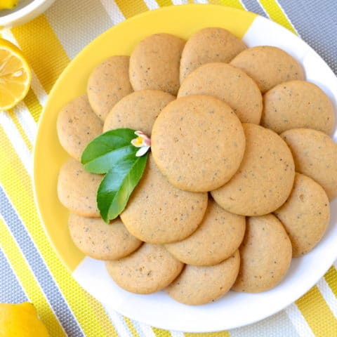 Soft, Vegan Lemon Poppy Seed Cookies, a simple recipe that's bursting with fresh lemon flavor. These melt-in-your-mouth cookies are free of egg, dairy and refined sugar –which makes them a healthier option! Flavored with fresh squeezed lemon juice, these soft and tender cookies are sure to be your new favorite treat!