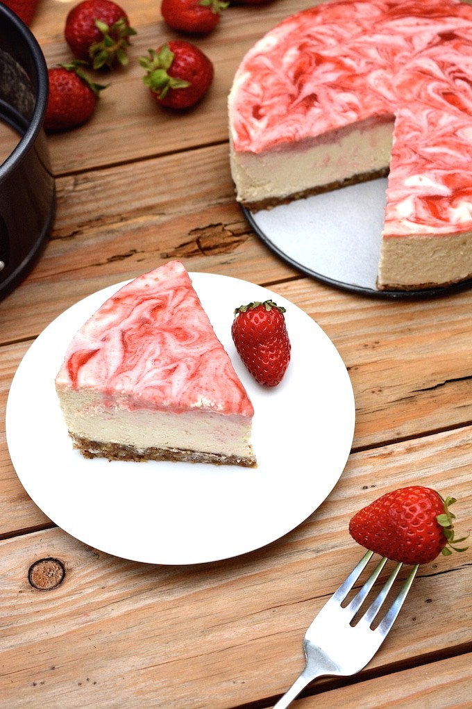 A vegan No-Bake Strawberry Swirl Cheesecake worth hoarding! It has the authentic cheesecake taste without the heavy dairy. This healthier, rich & creamy cheesecake is easy to whip-up, only takes 10 ingredients and includes a fresh strawberry swirl top with extra for drizzling! (vegan, dairy-free, gluten-free)