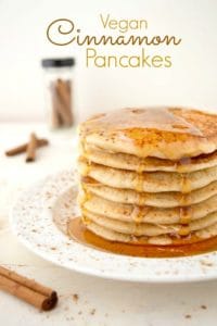 Stack of vegan cinnamon pancakes with maple syrup dripping down.