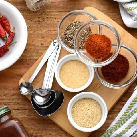 5 spice cajun seasoning in separate bowls ready to mix.