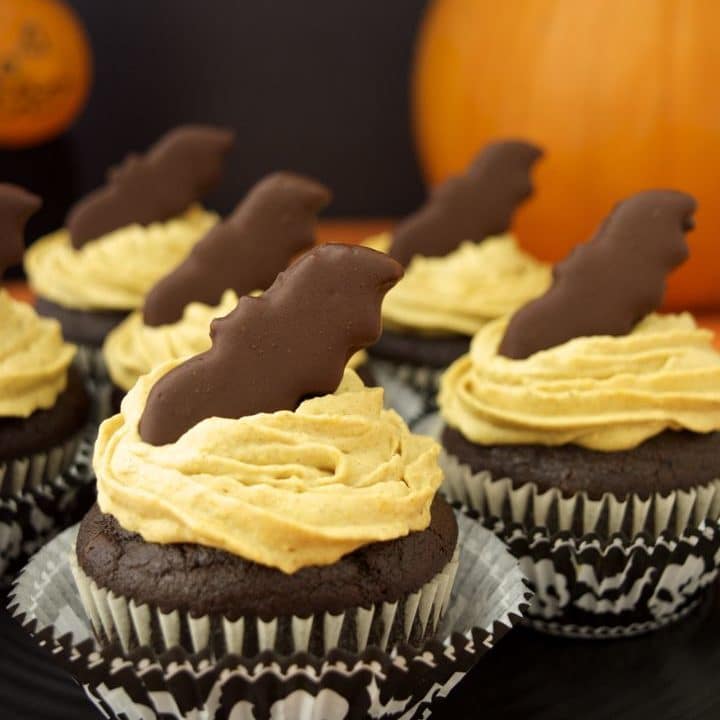 Pumpkin Frosted Chocolate Cupcakes with Bat Bites are a healthier, vegan holiday-inspired dessert. The pumpkin spiced frosting is made from whipped coconut cream and real pumpkin purée. And the cupcakes are rich and chocolatey with the addition of chocolate chips. Top them with a thin mint bat cookie for a spooky fun halloween treat!