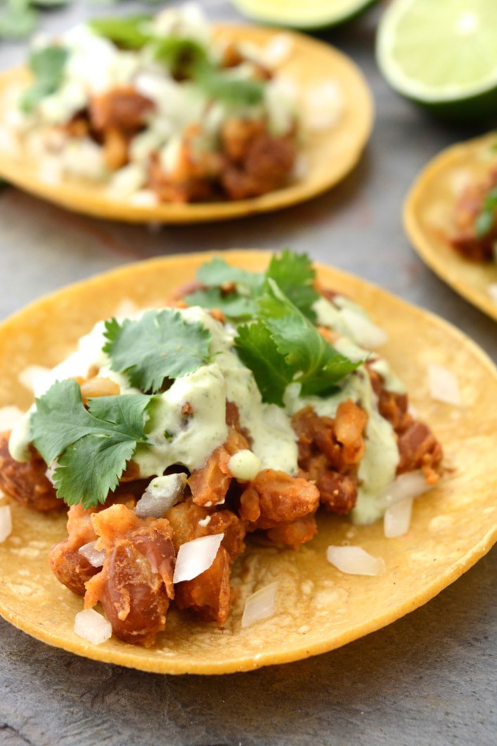 Vegan Tacos with Cilantro Lime Sauce are gluten-free and oil-free. These healthy 20 minute vegan tacos are so easy to make and only take one pan! The filling is made with seasoned pinto beans and rice. Then the tacos are topped with a tangy cilantro lime sauce.