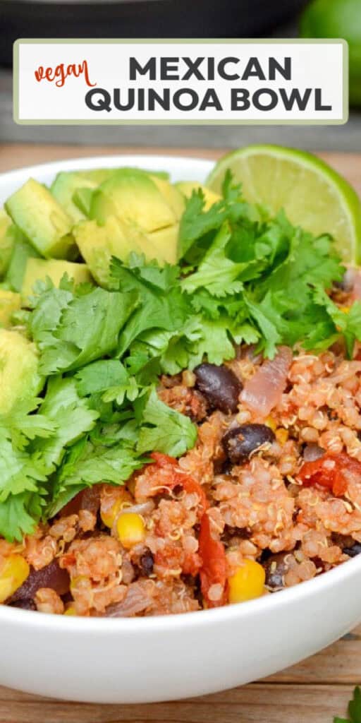 A white bowl of vegan Mexican quinoa topped with fresh cilantro, diced avocado, and lime wedge.