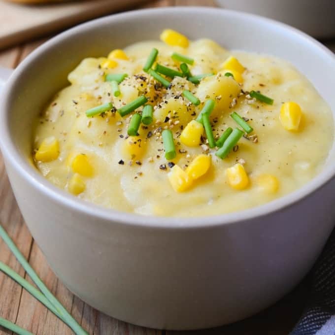 Vegan potato corn chowder topped with fresh pepper and green onions.