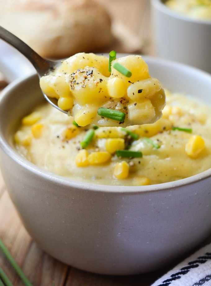 Vegan Potato Corn Chowder- A spoonful of chunky potatoes, diced white carrots, sweet corn and topped with fresh green onions and black pepper.
