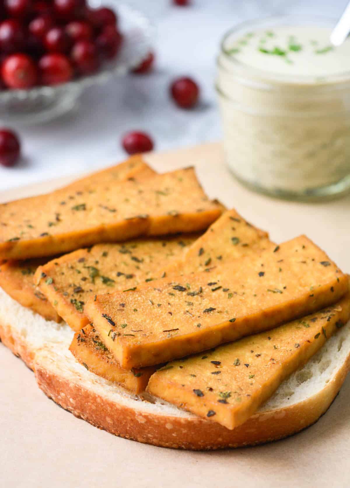 Herb-marinated tofu on a slice of toasted bread.