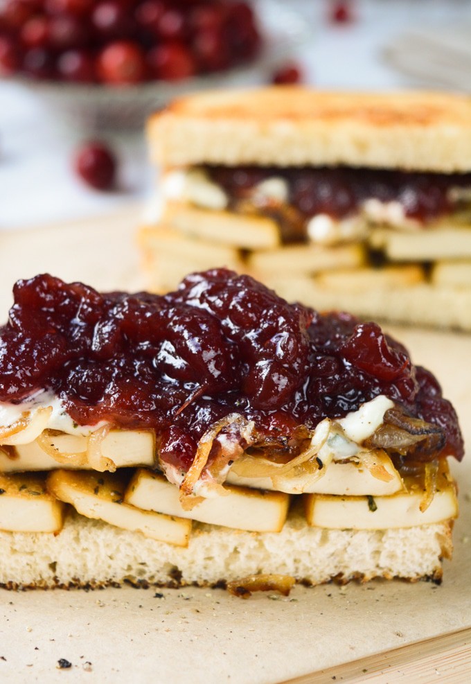 Vegan Holiday Sandwich-- Sourdough bread piled with herb tofu, caramelized onions, savory herb dressing and cranberry sauce. 