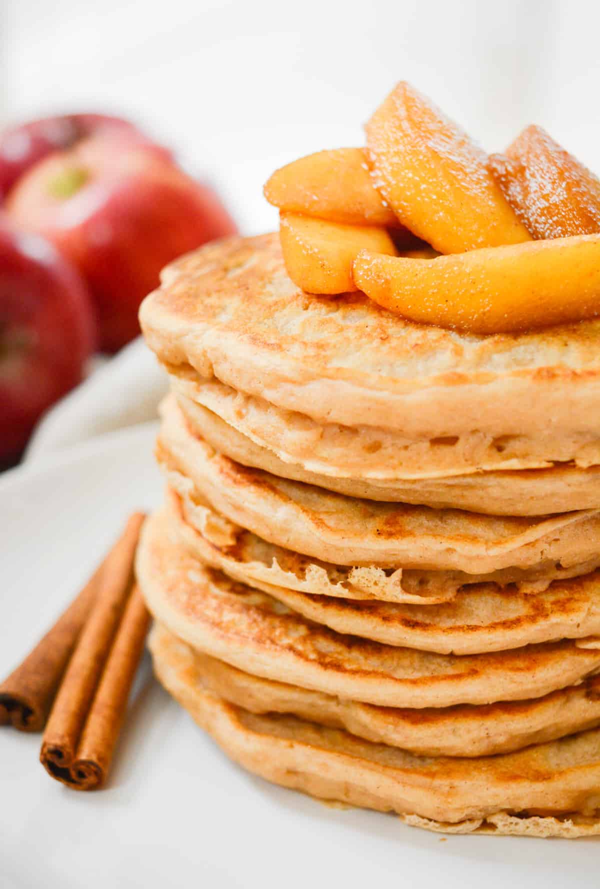 Apple Cinnamon Pancakes topped with cooked apples.