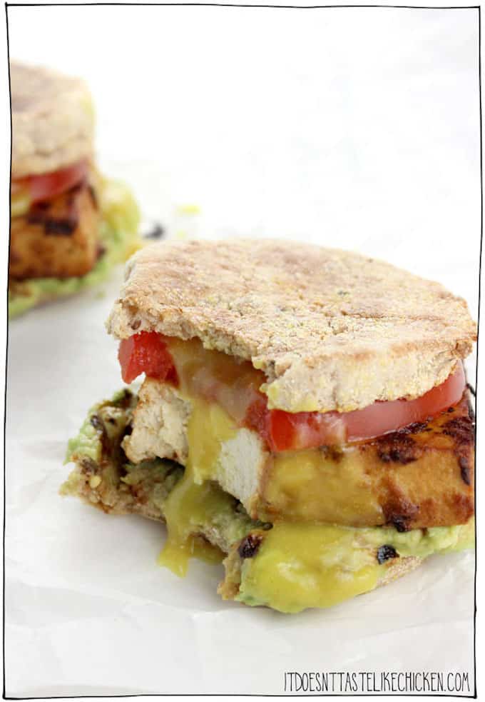 Flavored tofu, tomatoes, and avocado on an english muffin.