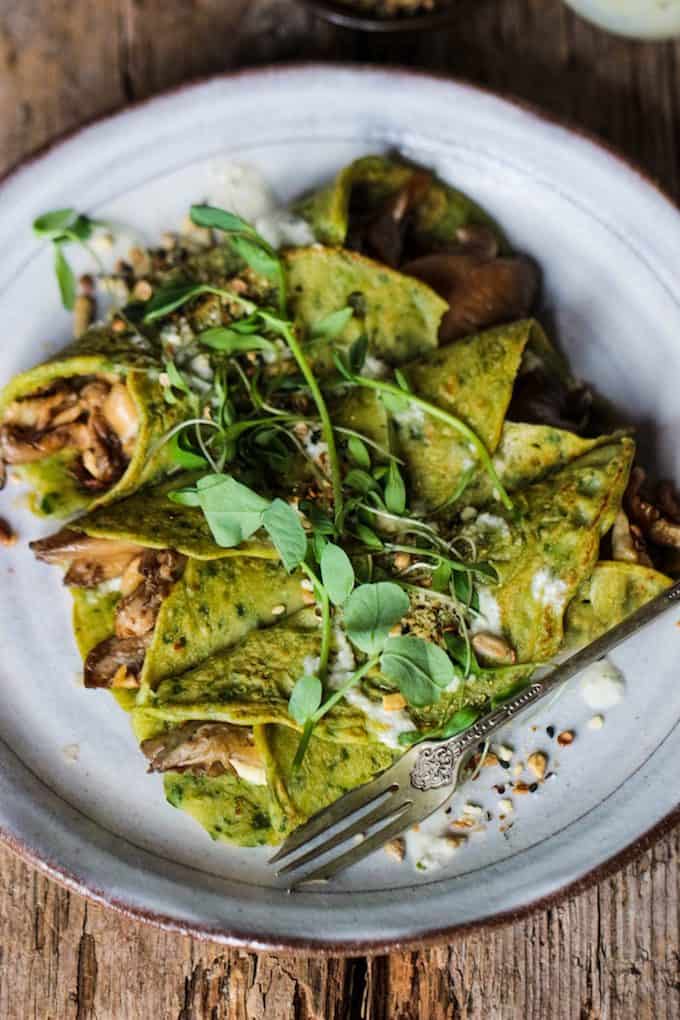 spinach crepes topped with fresh herbs.