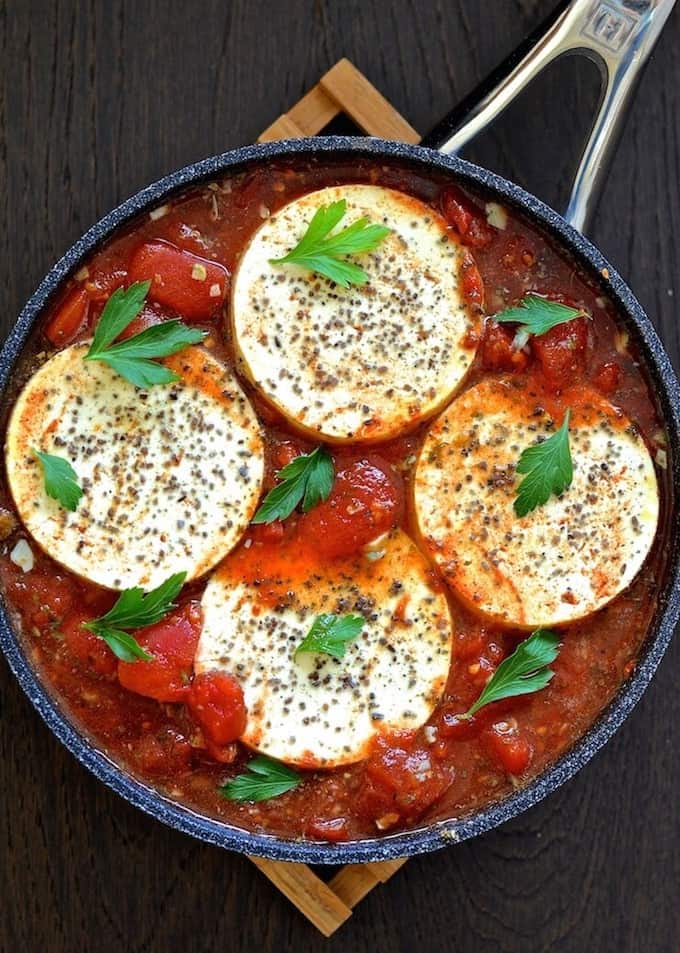 Tofu rounds in a tomato based sauce.
