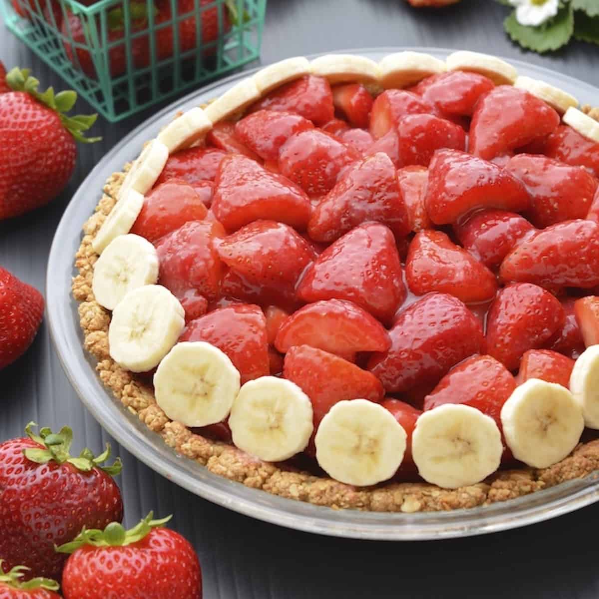 Vegan strawberry pie in a glass pie dish.
