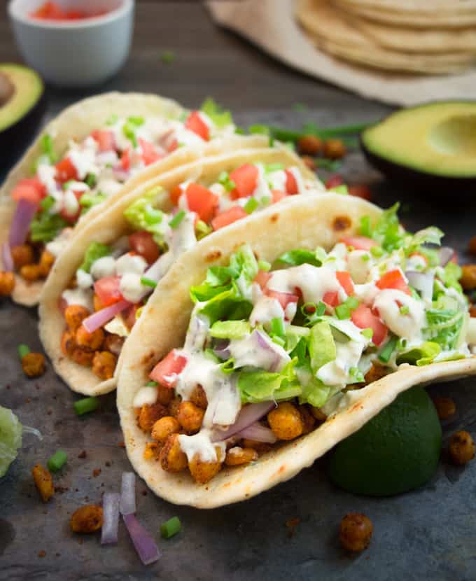 3 vegan chickpea soft tacos stuffed with taco seasoned chickpeas, lettuce, onions, tomatoes and a cheesy vegan ranch dressing.