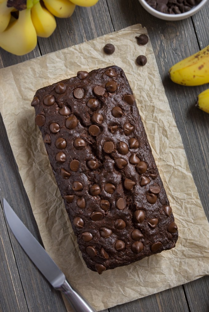a top image of a loaf of vegan chocolate banana bread topped with chocolate chips.