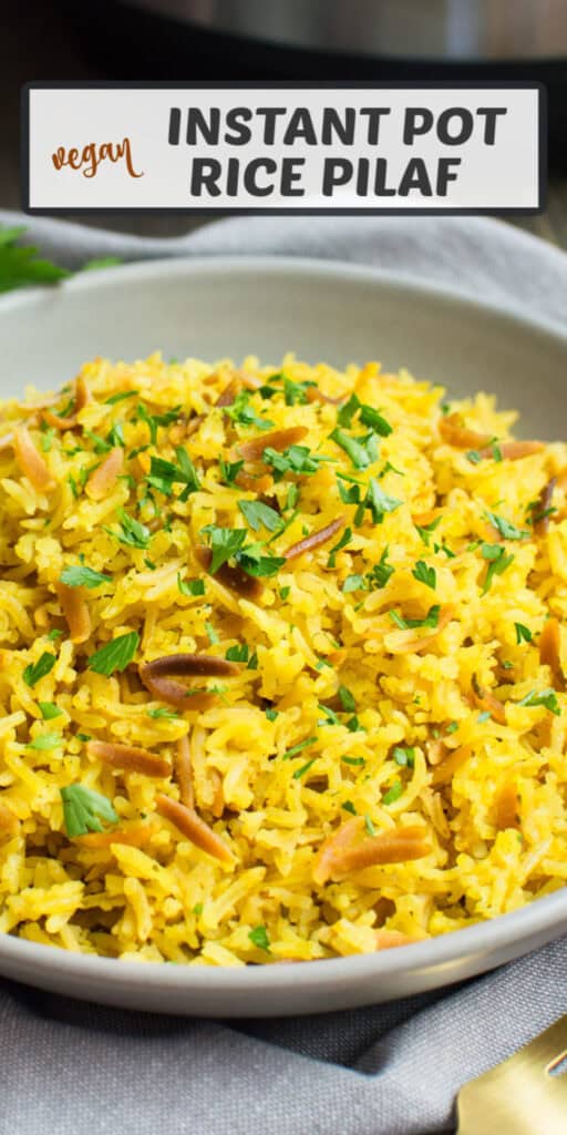 Rice pilaf on a serving plate topped with fresh parsley.