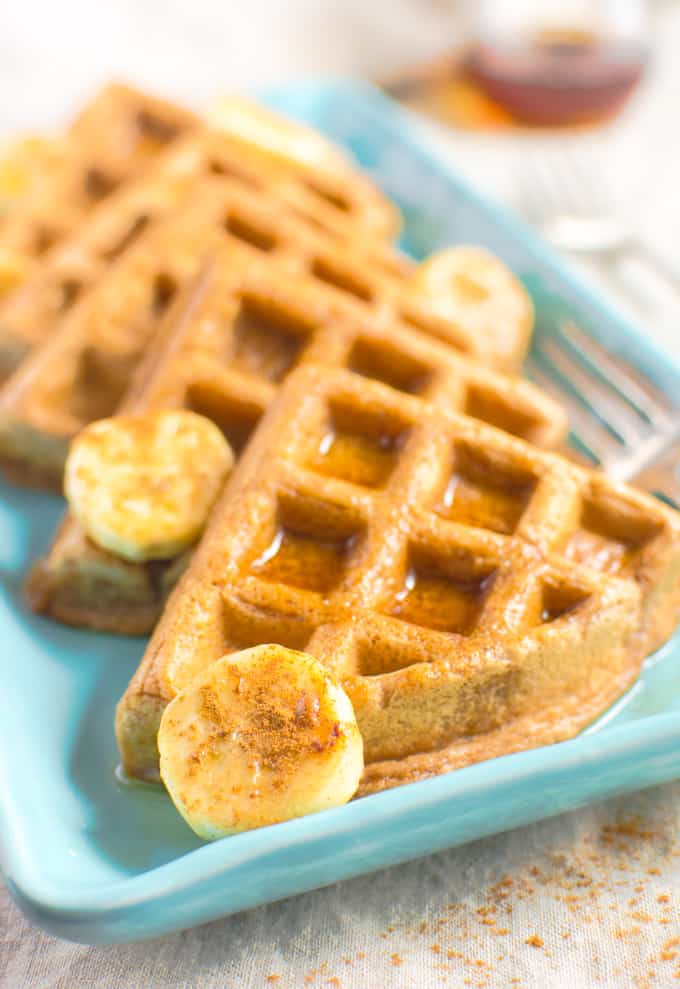 Cinnamon Vegan Waffle triangles topped with bananas and maple syrup.