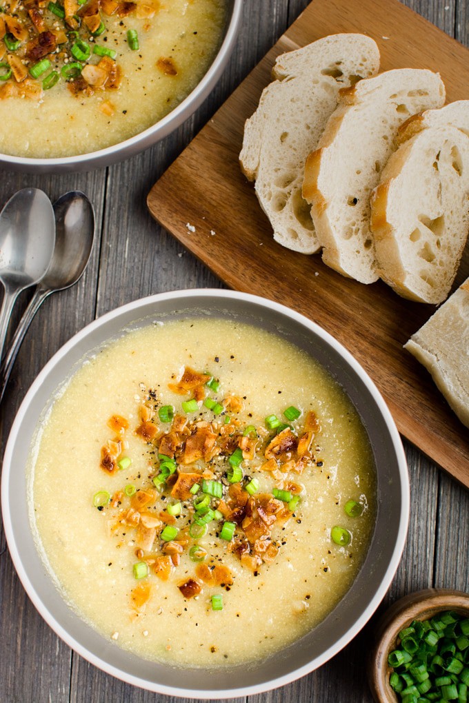 2 bowls of vegan Cauliflower Leek Soup served with a loaf of fresh baked french bread..