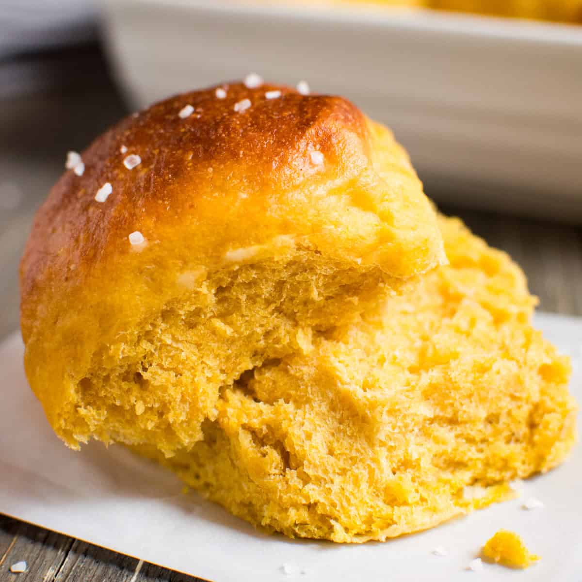 pumpkin dinner roll torn in half.