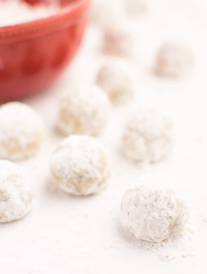 Vegan snowball cookies after rolling in powdered sugar.