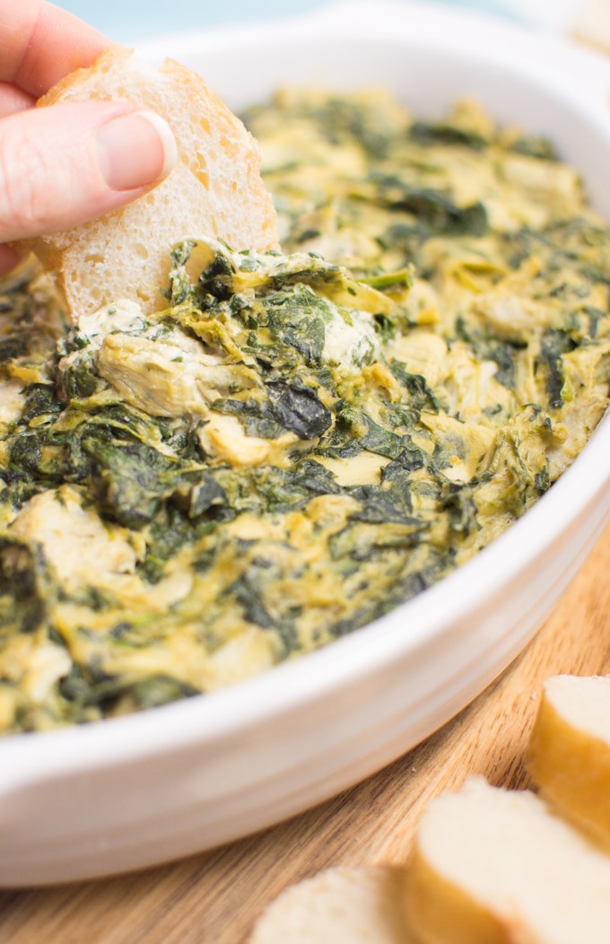 21 vegan party food favorites - spinach artichoke dip with baguette.