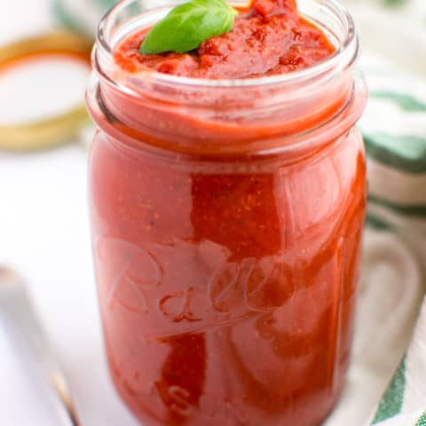 Homemade marinara sauce in a glass jar.