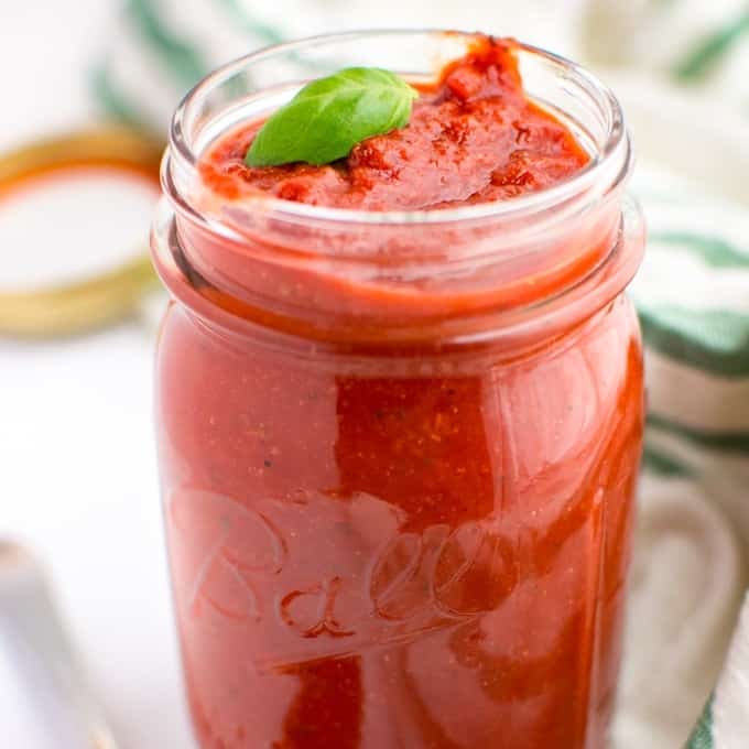 An open mason jar filled with marinara