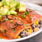 Black bean enchiladas topped with freshly diced avocado.