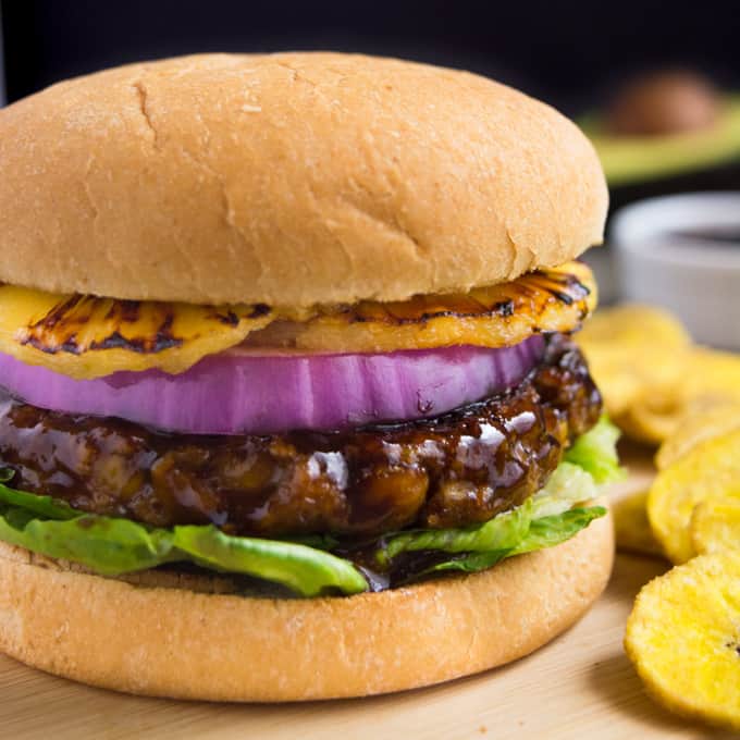 Vegan burger with huli huli sauce, red onion and grilled pineapple rounds.