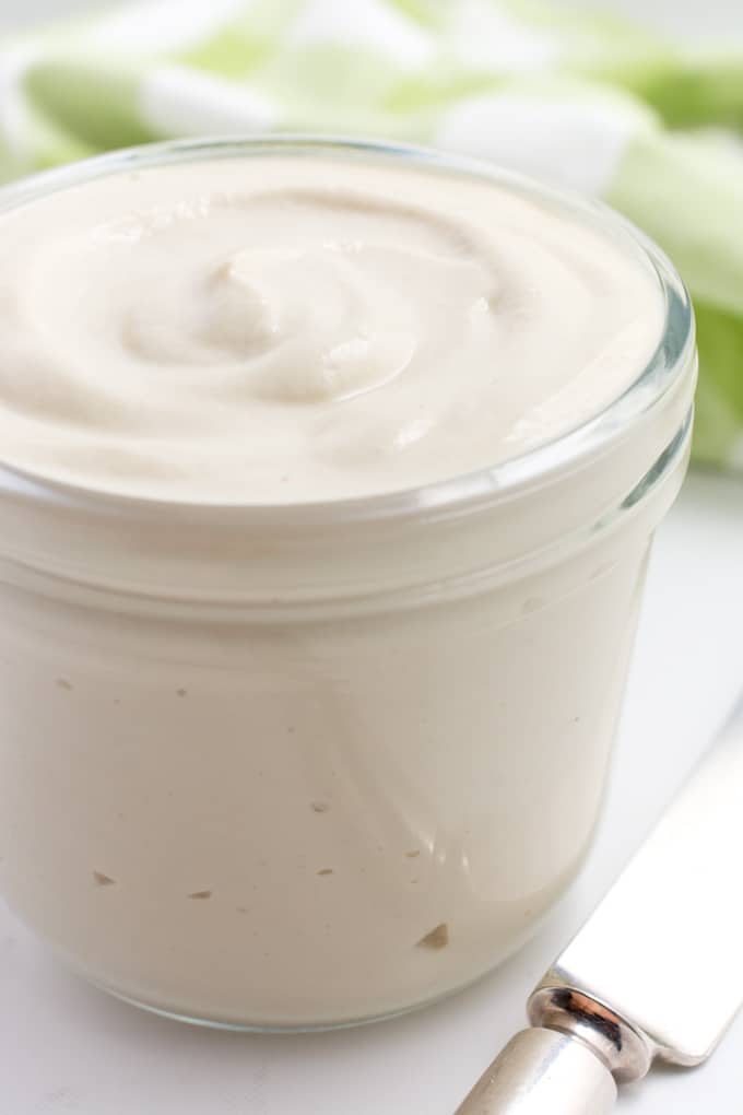 Cashew mayo in a glass jar from the side.