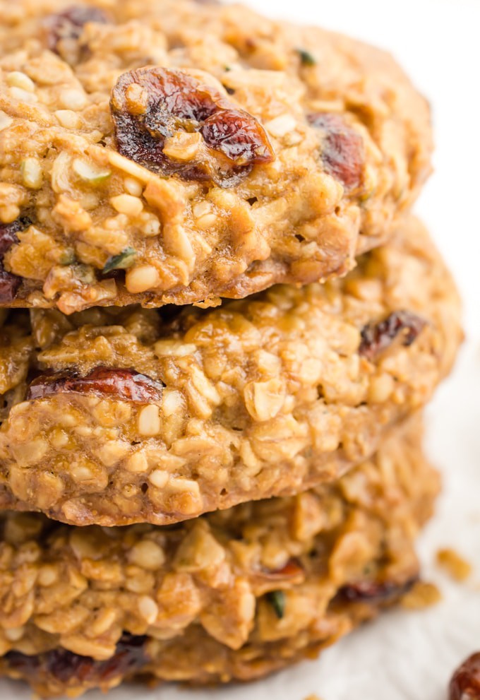 A stack of 3 vegan breakfast cookies with dried cranberries and hemp seeds.