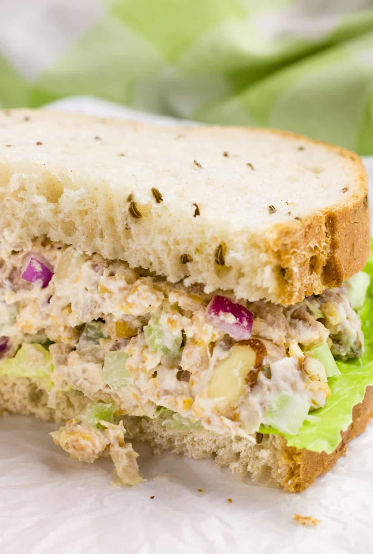 Vegan chicken salad on seeded bread with lettuce.