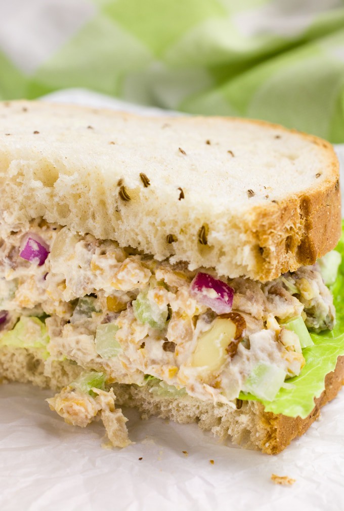 Vegan chicken salad on rye bread cut in half.