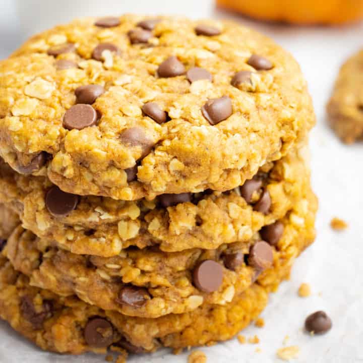 A stack of vegan pumpkin oatmeal cookies with chocolate chips.