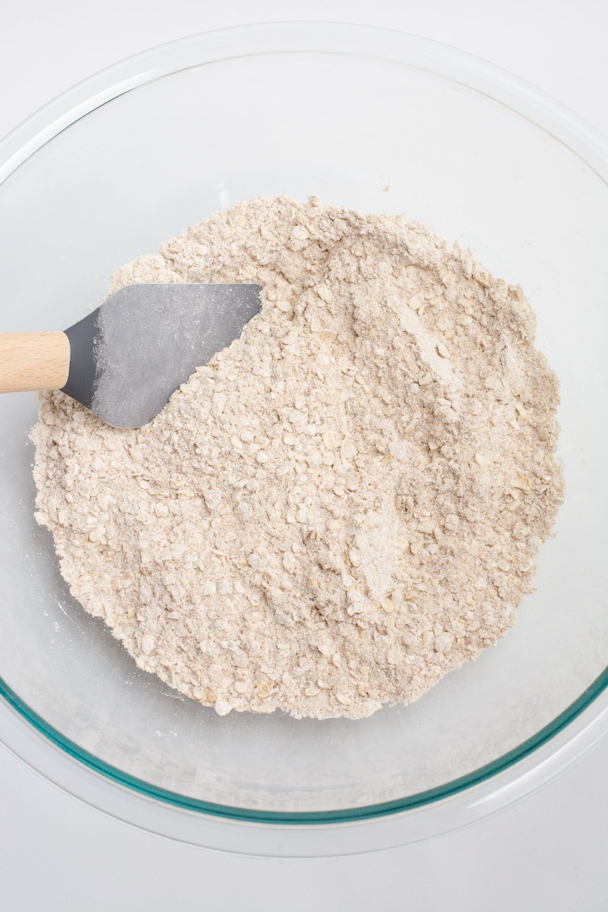 Vegan oatmeal cookie dry ingredients mixed in a glass bowl.