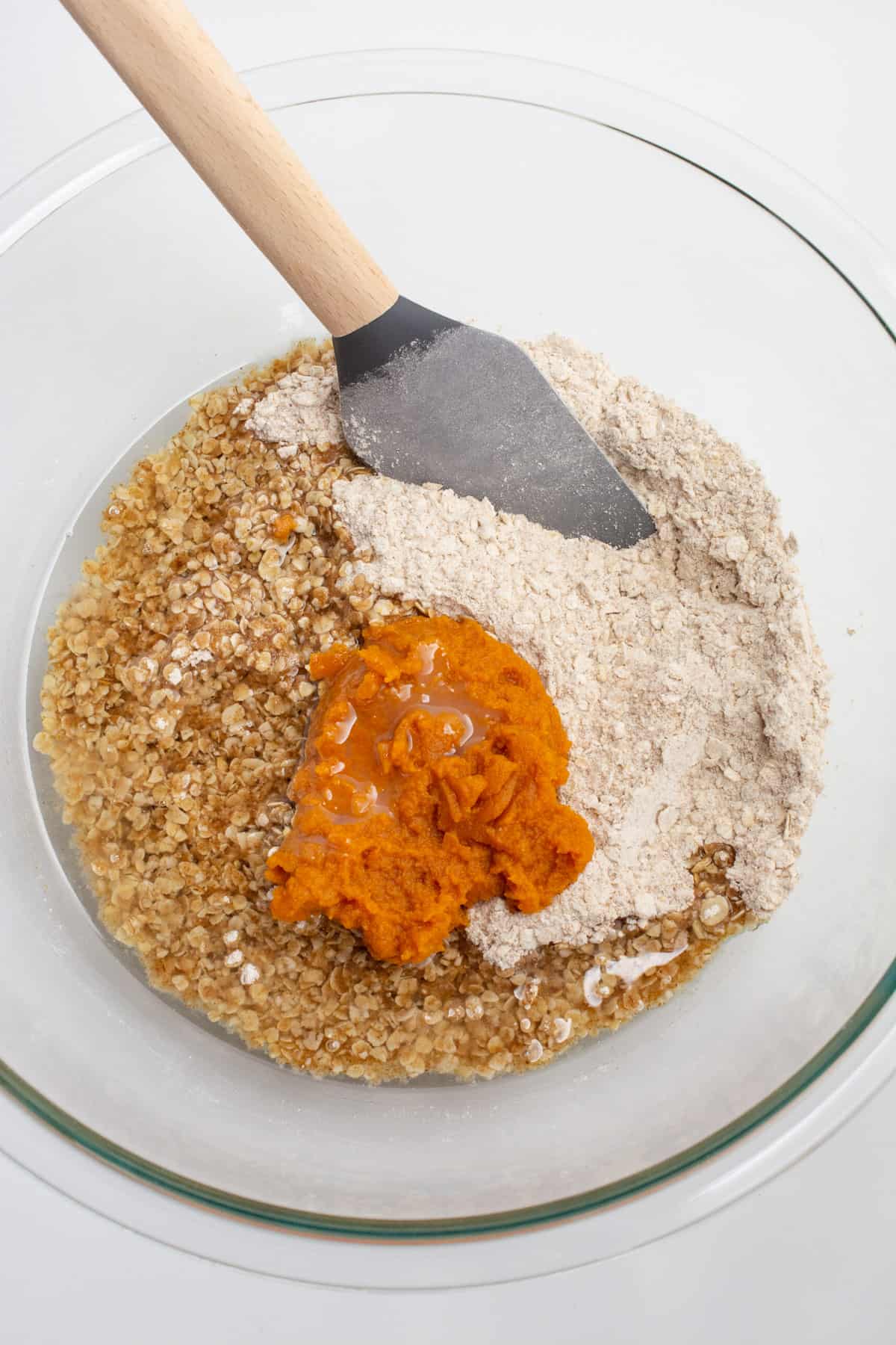 Ingredients for vegan pumpkin oatmeal cookies in a glass bowl.