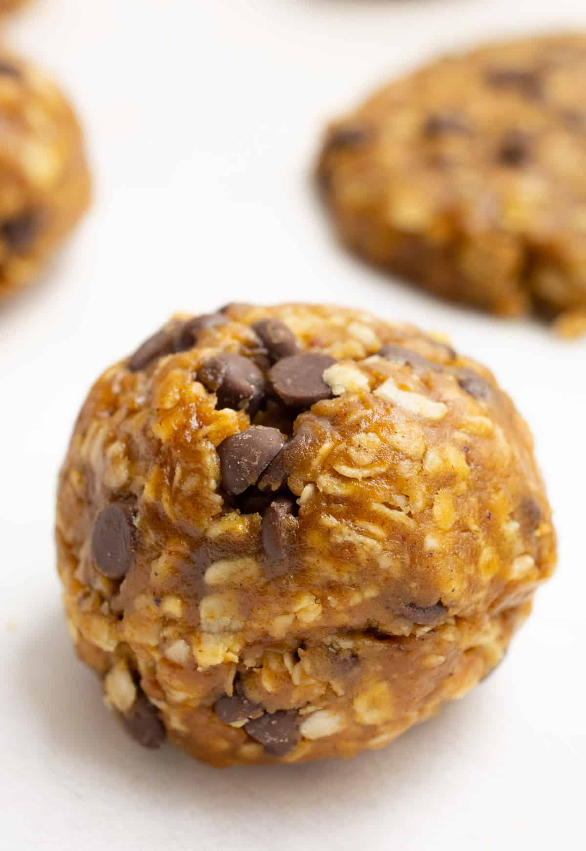 Cookie dough formed into a ball on parchment paper.