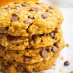 A stack of vegan pumpkin oatmeal cookies with chocolate chips.