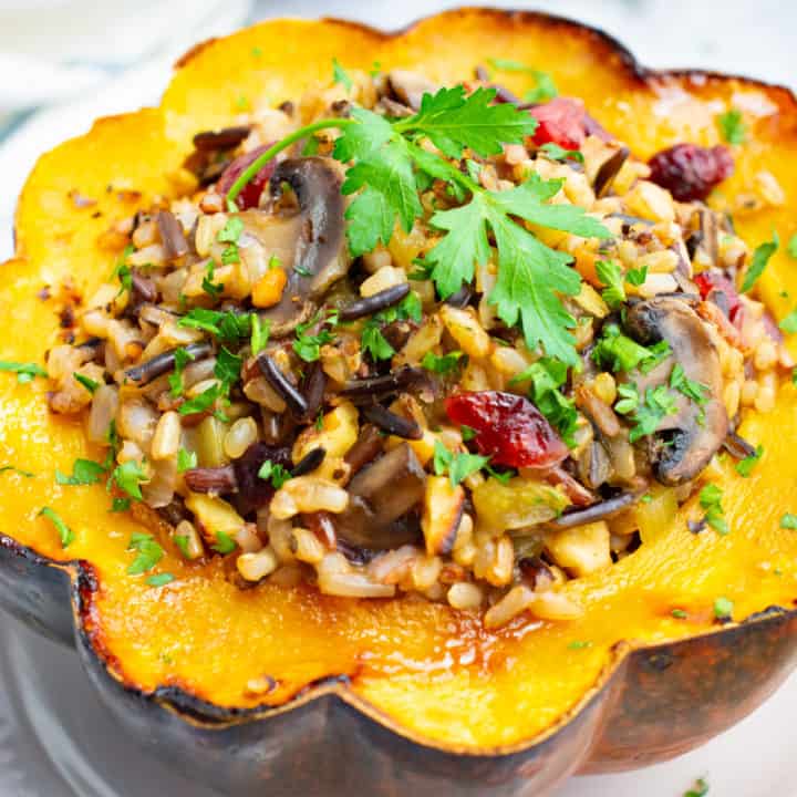 Vegetarian wild rice stuffed acorn squash with sautéed mushrooms, dried cranberries and toasted walnuts.