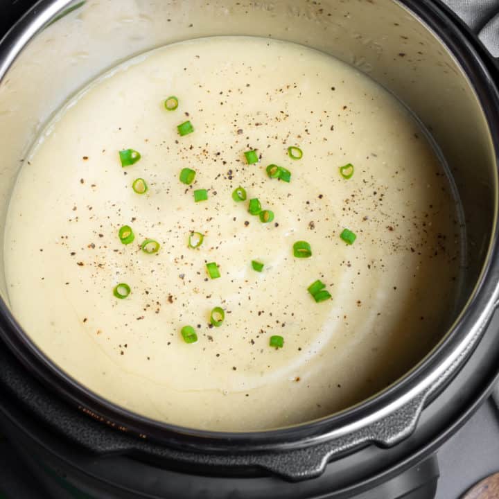 Potato soup in the Instant pot topped with green onions and pepper.