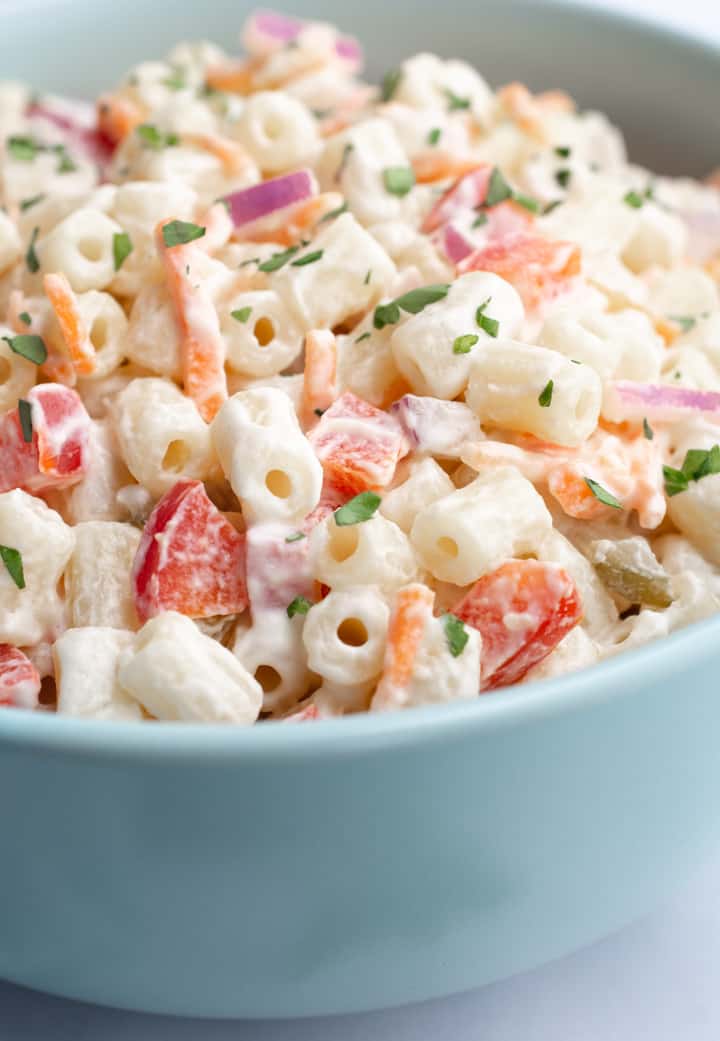 Vegan macaroni salad with bell peppers, onion, carrots ,relish, and parsley.
