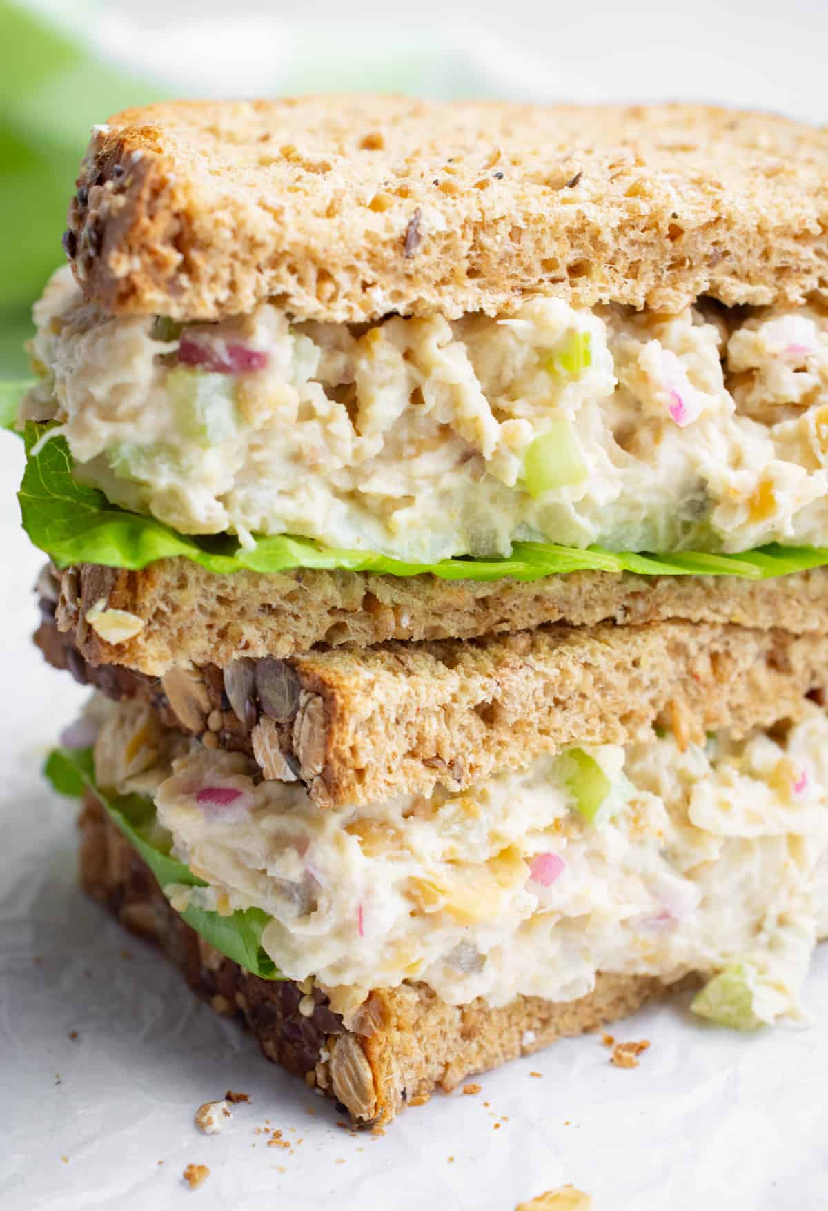 Vegan tuna salad sandwich cut in half and stacked.