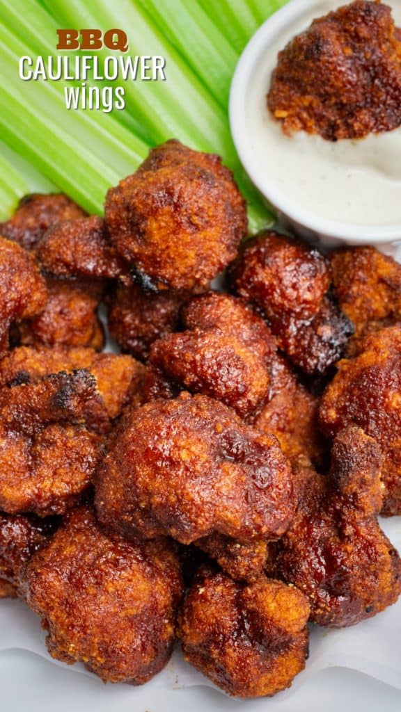 Vegan BBQ cauliflower wings with ranch and celery sticks.