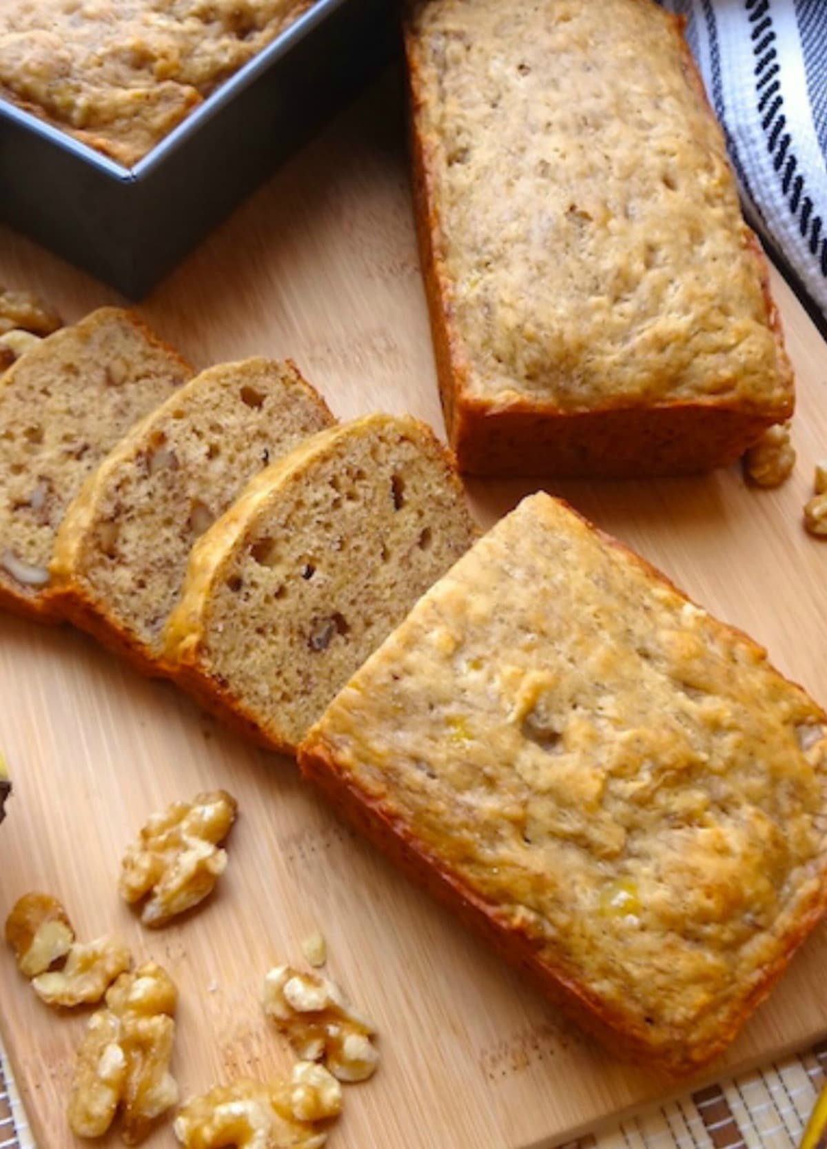 Close up of vegan banana bread with 3 slices cut.