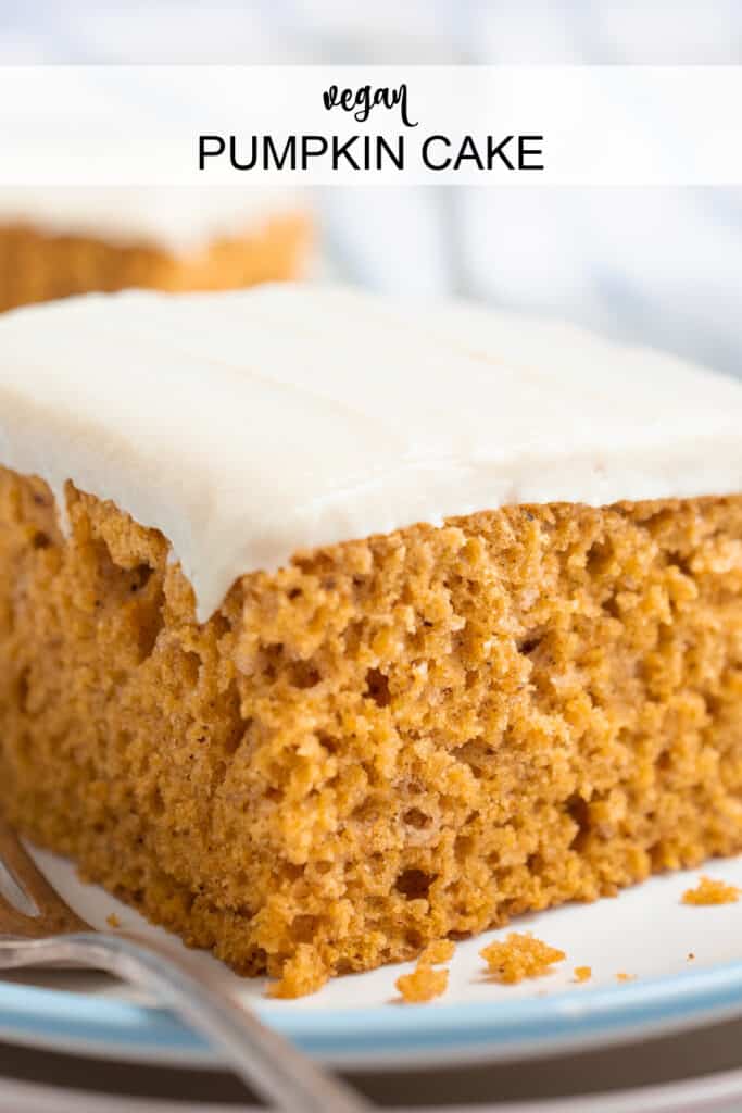 A slice of vegan pumpkin cake topped with frosting.