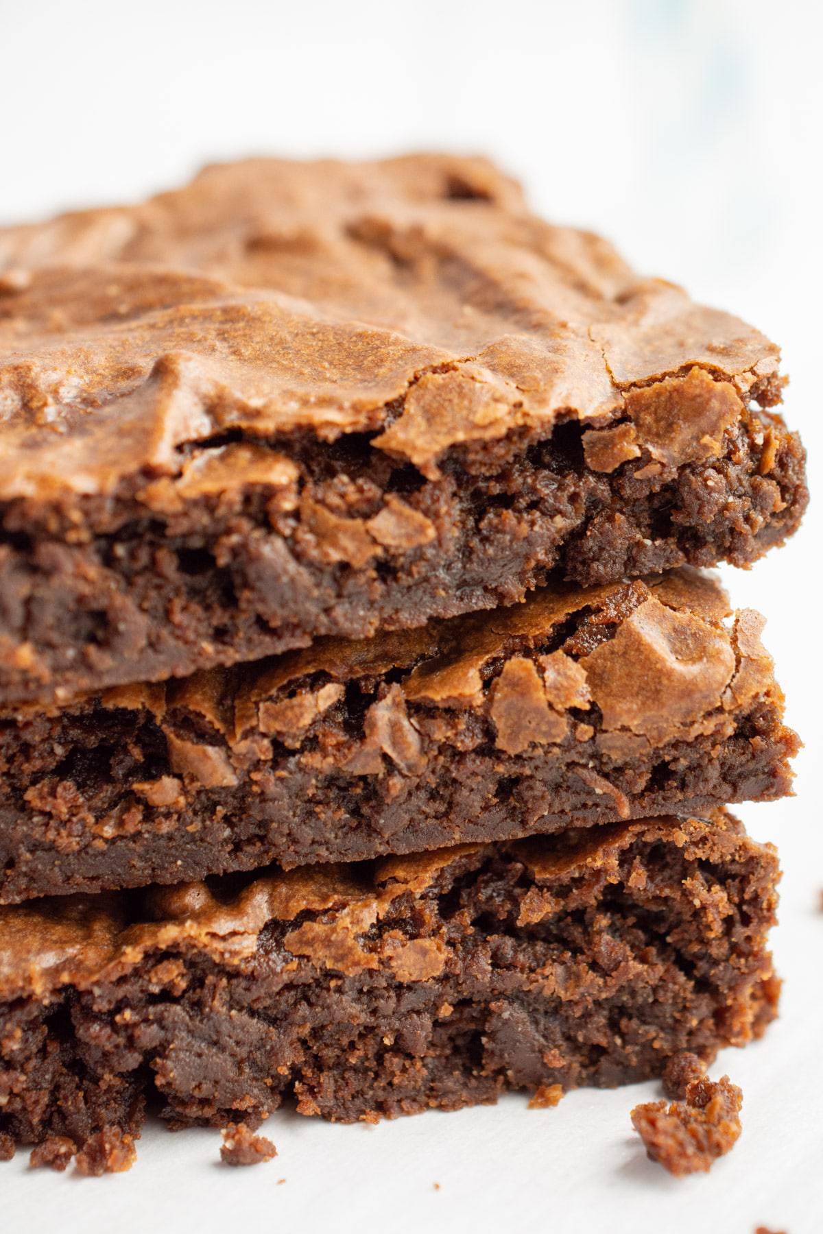 Three chocolatey vegan brownies stacked.