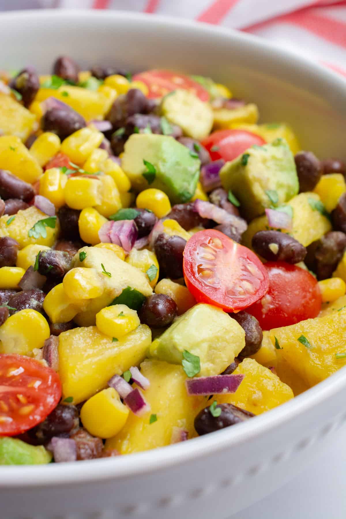 A closeup of a bowl of pineapple black bean salad.