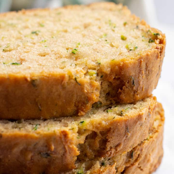 3 stacked slices of zucchini bread.